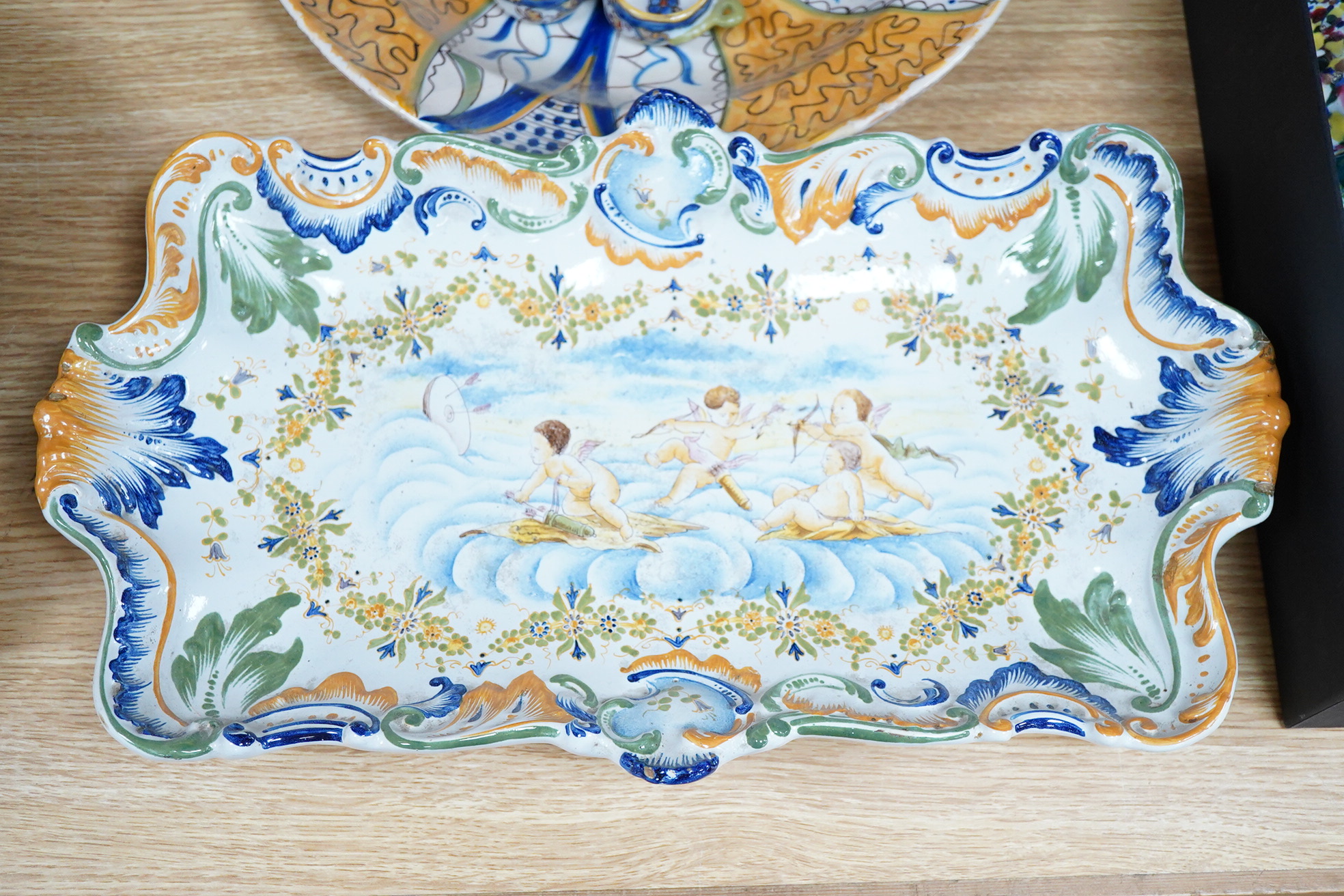 Two 18th century Delft polychrome chargers, five other faience chargers, a rectangular 19th century French faience dish and a blue and white letter rack